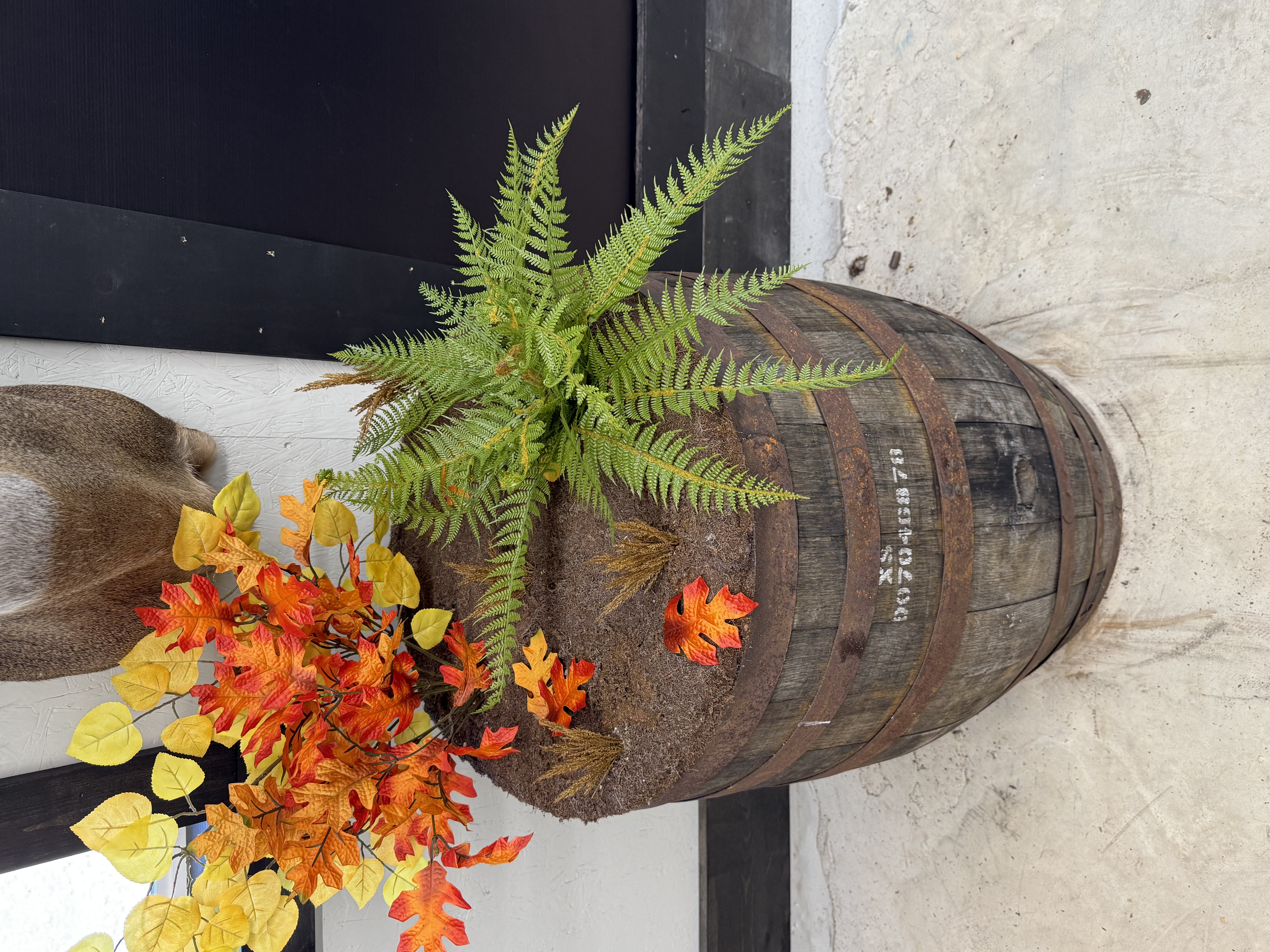 Custom whiskey barrel base with fern and fall foliage